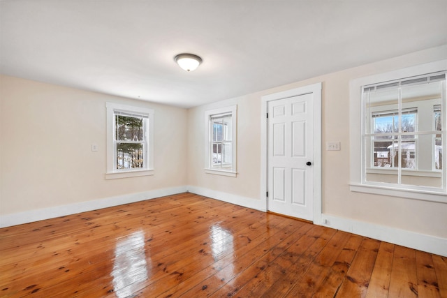 interior space with wood-type flooring and baseboards