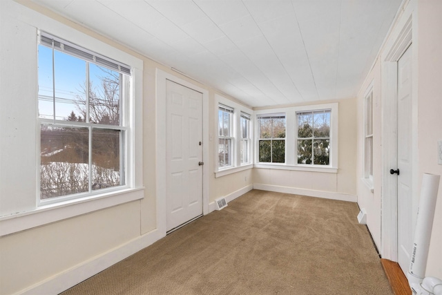 unfurnished sunroom with a healthy amount of sunlight and visible vents