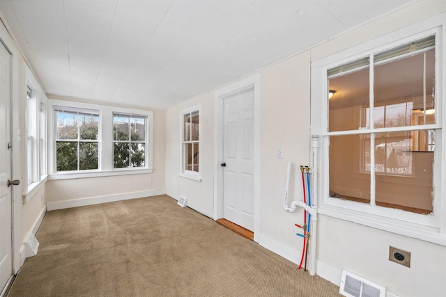 unfurnished sunroom featuring visible vents