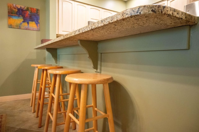 bar with a bar and baseboards