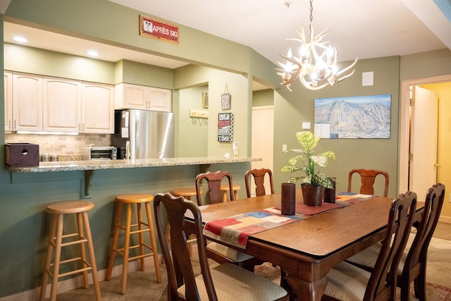 dining room with light tile patterned floors, recessed lighting, and an inviting chandelier