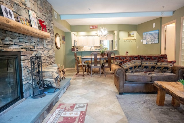 living area featuring light tile patterned flooring, a fireplace, visible vents, and a notable chandelier