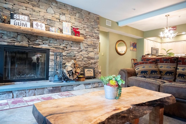 dining room featuring a notable chandelier, visible vents, beam ceiling, and a stone fireplace