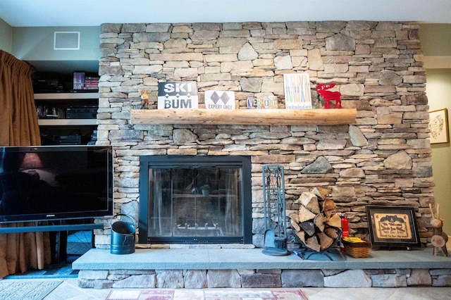 interior details featuring a stone fireplace