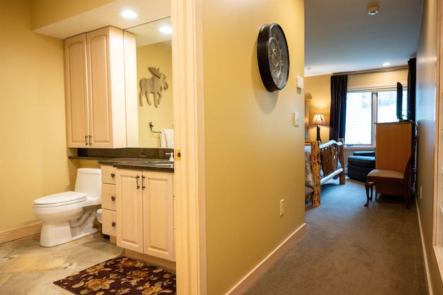 bathroom with recessed lighting, baseboards, vanity, and toilet