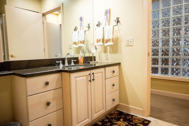 bathroom featuring vanity and baseboards