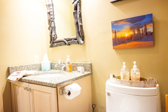 half bathroom with vanity and toilet