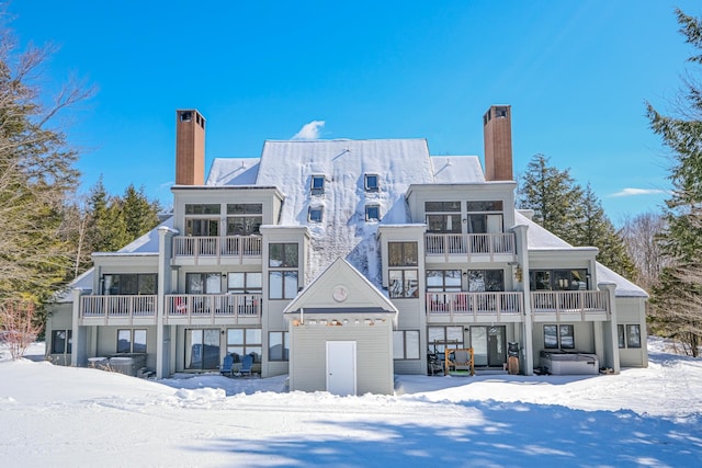 snow covered property featuring a chimney