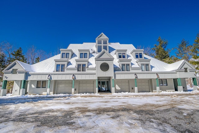 snow covered building with a garage