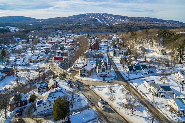 snowy aerial view with a residential view and a mountain view