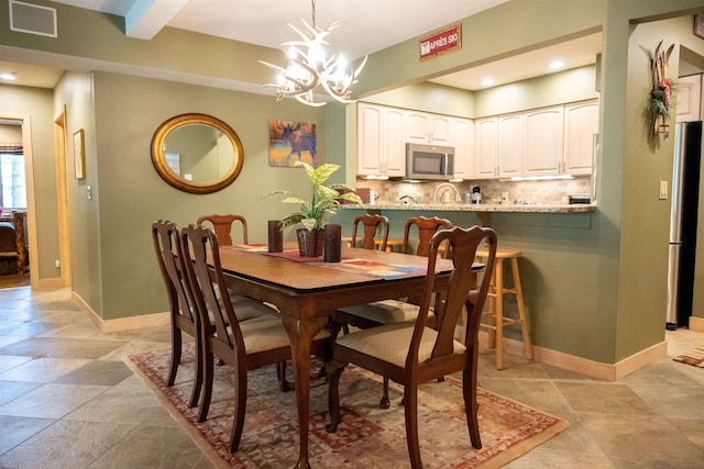 dining space featuring visible vents, baseboards, a chandelier, beam ceiling, and recessed lighting