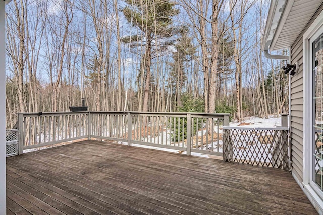 wooden terrace with a wooded view