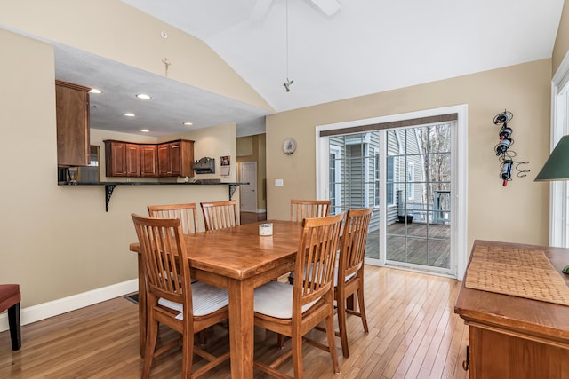 dining area with recessed lighting, light wood-type flooring, baseboards, and vaulted ceiling