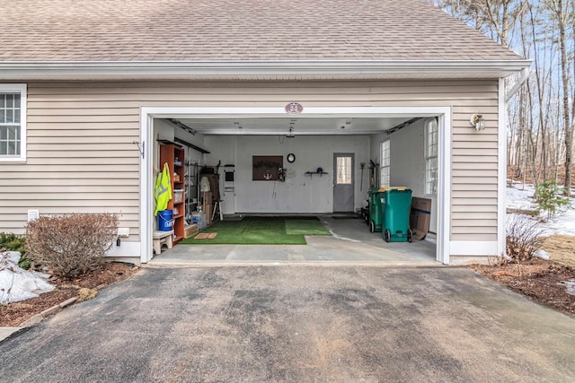 garage featuring aphalt driveway