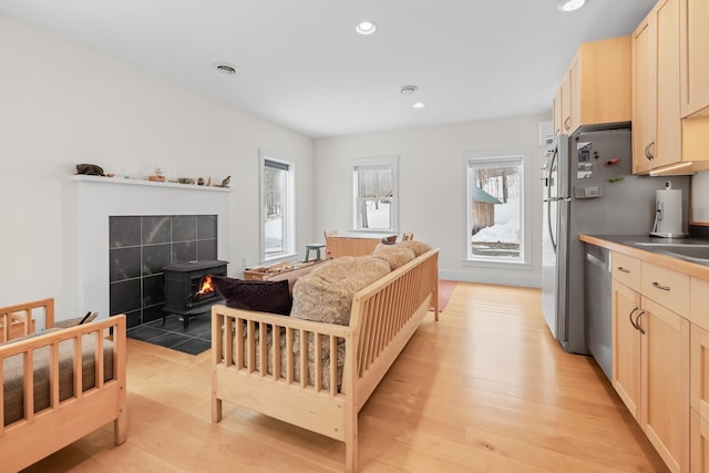 kitchen with light brown cabinets, recessed lighting, visible vents, light wood-style floors, and dishwasher