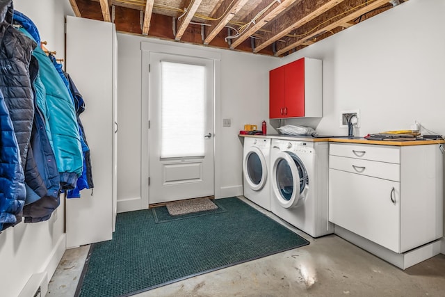 laundry area featuring washing machine and dryer and cabinet space