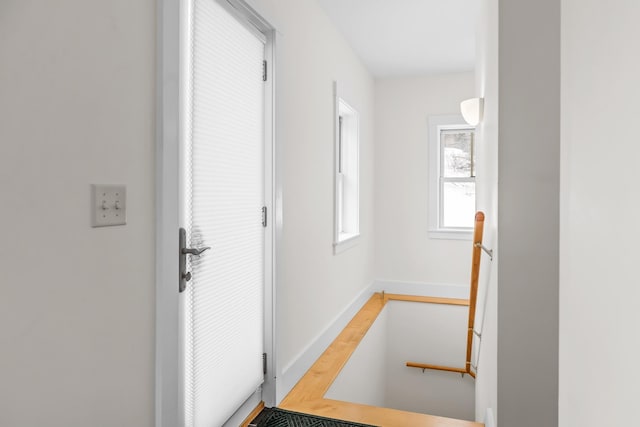 entryway with light wood-type flooring and baseboards