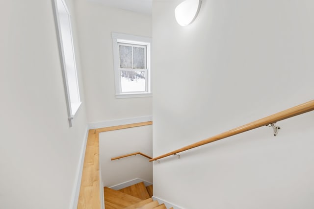 stairs featuring baseboards and wood finished floors