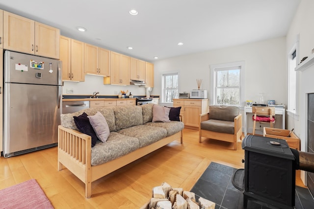 living area featuring light wood-type flooring and recessed lighting