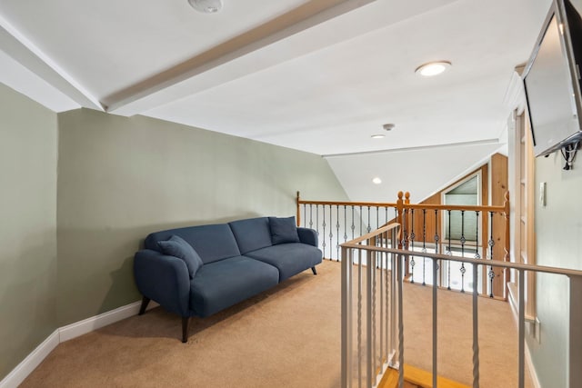 interior space featuring vaulted ceiling, baseboards, and light colored carpet