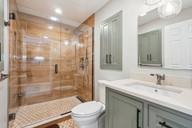 full bath featuring toilet, a stall shower, and vanity