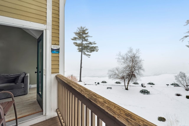 view of snow covered back of property