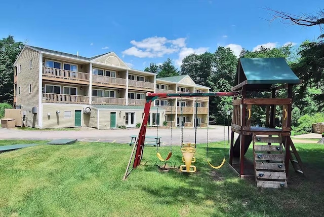 community jungle gym featuring a yard