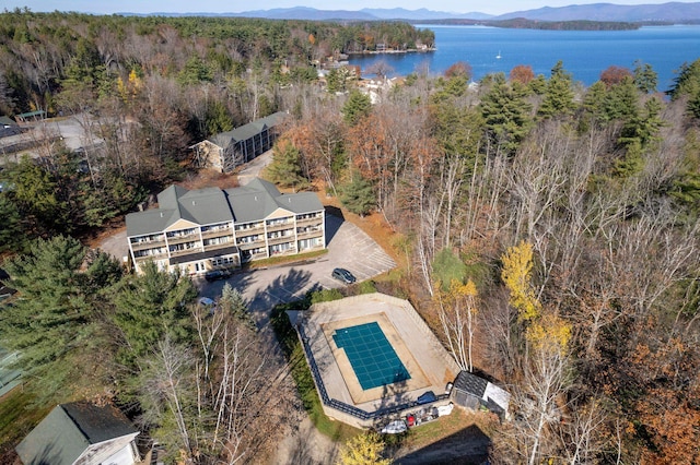 bird's eye view with a water and mountain view and a wooded view