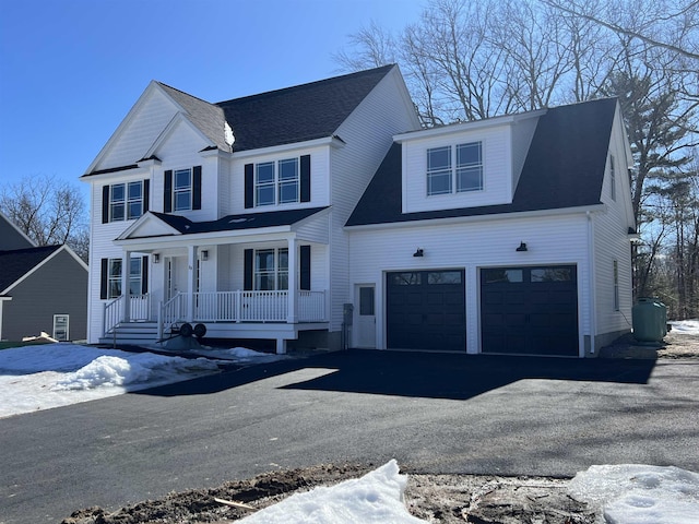 view of front of property with a garage, aphalt driveway, and a porch