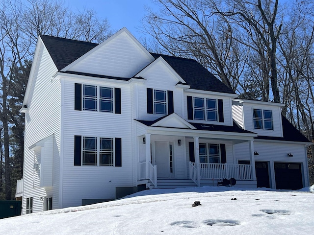 view of front of property featuring an attached garage and covered porch