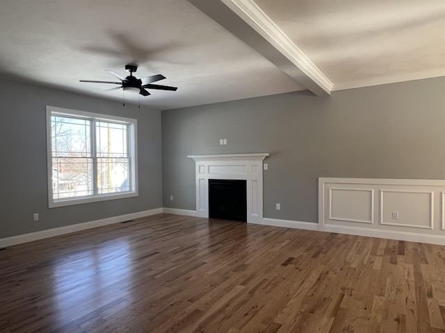 unfurnished living room with baseboards, a fireplace, a ceiling fan, and wood finished floors