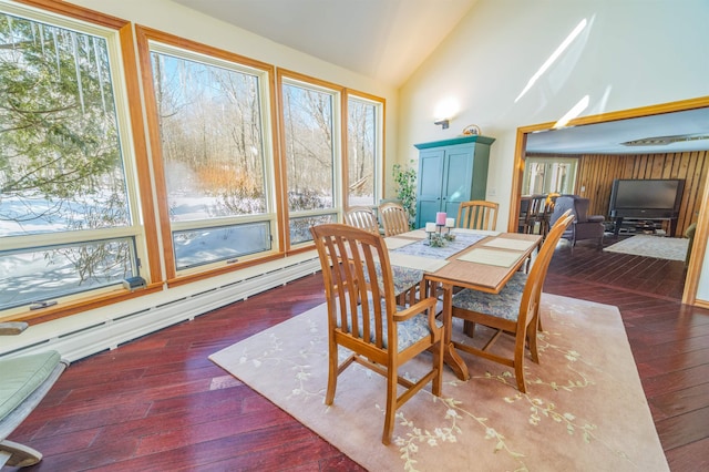 dining room with high vaulted ceiling, wood-type flooring, and baseboard heating