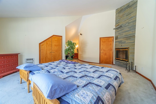 bedroom with high vaulted ceiling, a stone fireplace, carpet flooring, and baseboards