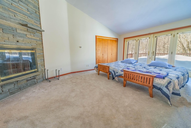 bedroom with access to outside, carpet flooring, french doors, a fireplace, and high vaulted ceiling