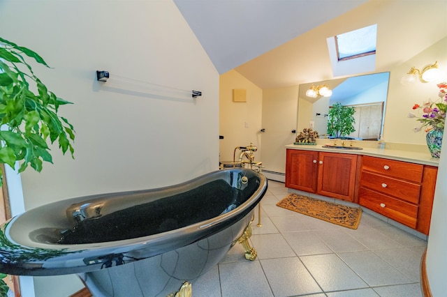 bathroom featuring vaulted ceiling with skylight, a baseboard radiator, tile patterned flooring, a freestanding bath, and vanity