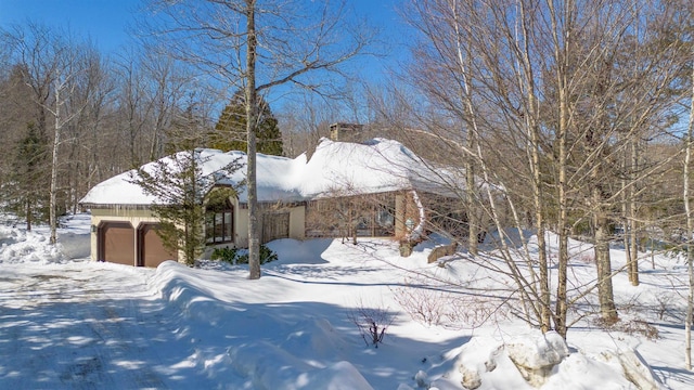 exterior space with a garage and stucco siding