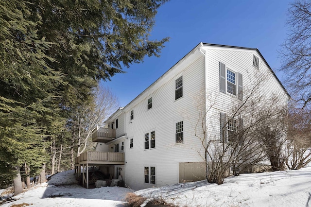 view of snow covered exterior with a balcony