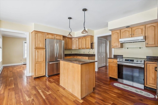 kitchen with dark wood-style floors, stainless steel appliances, a baseboard heating unit, a kitchen island, and under cabinet range hood