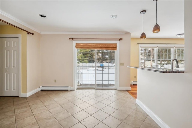 interior space with a baseboard heating unit, a healthy amount of sunlight, and ornamental molding