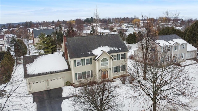 snowy aerial view with a residential view