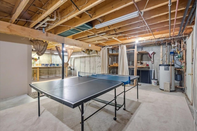 recreation room with concrete flooring and water heater