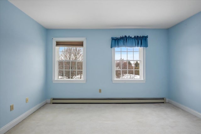 carpeted empty room with a baseboard radiator, a healthy amount of sunlight, and baseboards