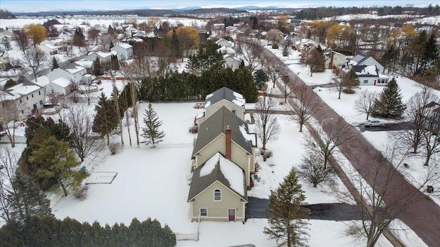 snowy aerial view featuring a residential view