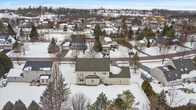 snowy aerial view with a residential view