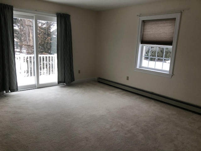 carpeted spare room with baseboard heating