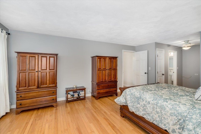 bedroom featuring baseboards and light wood finished floors