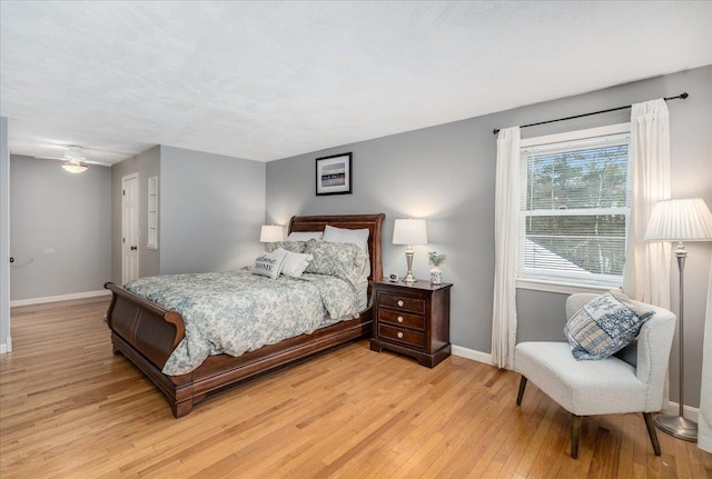 bedroom featuring light wood-type flooring and baseboards