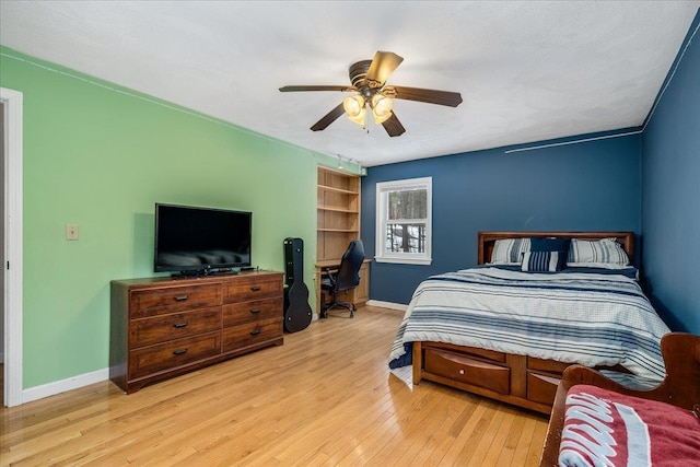 bedroom featuring hardwood / wood-style flooring, ceiling fan, and baseboards