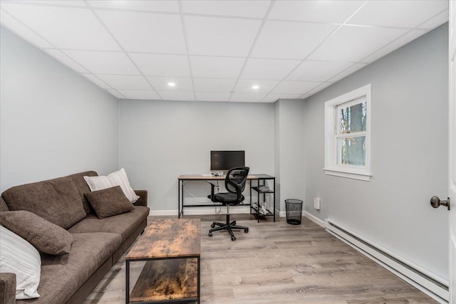 home office with a drop ceiling, recessed lighting, wood finished floors, baseboards, and baseboard heating