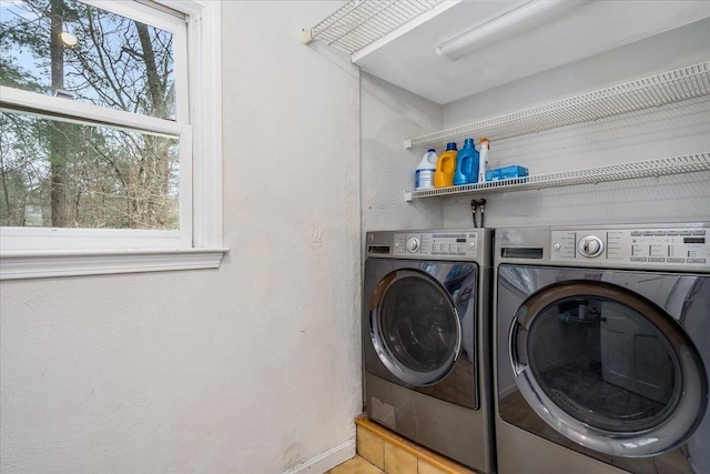 laundry area with laundry area, plenty of natural light, and washing machine and clothes dryer